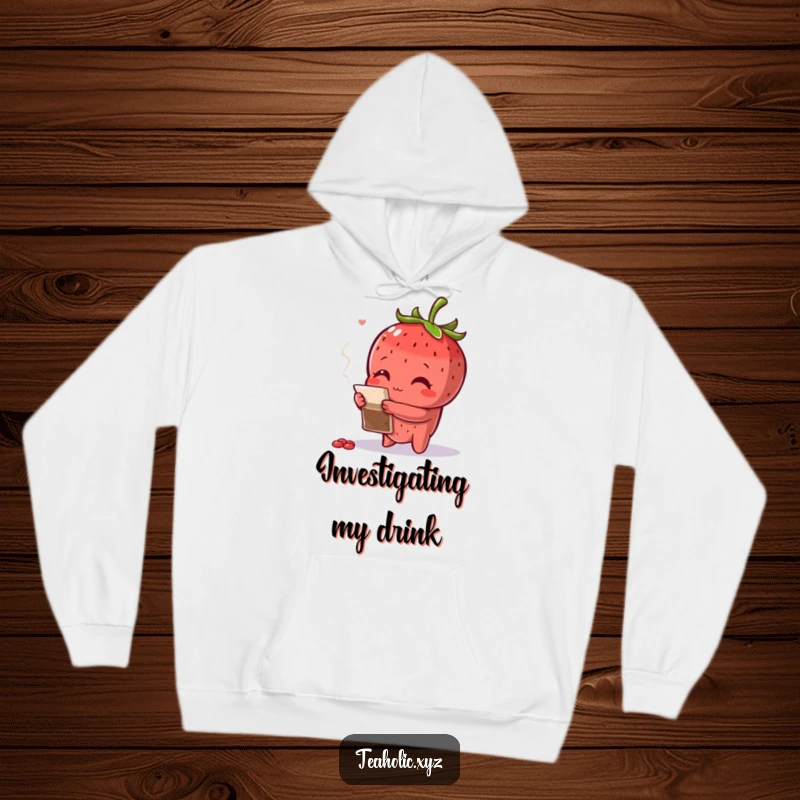 Funny curious strawberry with arms crossed, inspecting a teabag, featured on a cozy hoodie.