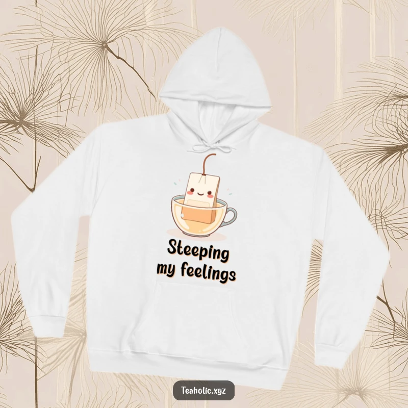 Funny Teabag Character Hoodie: A happy teabag with a dangling string happily dipping into hot water, cozy and relaxing.